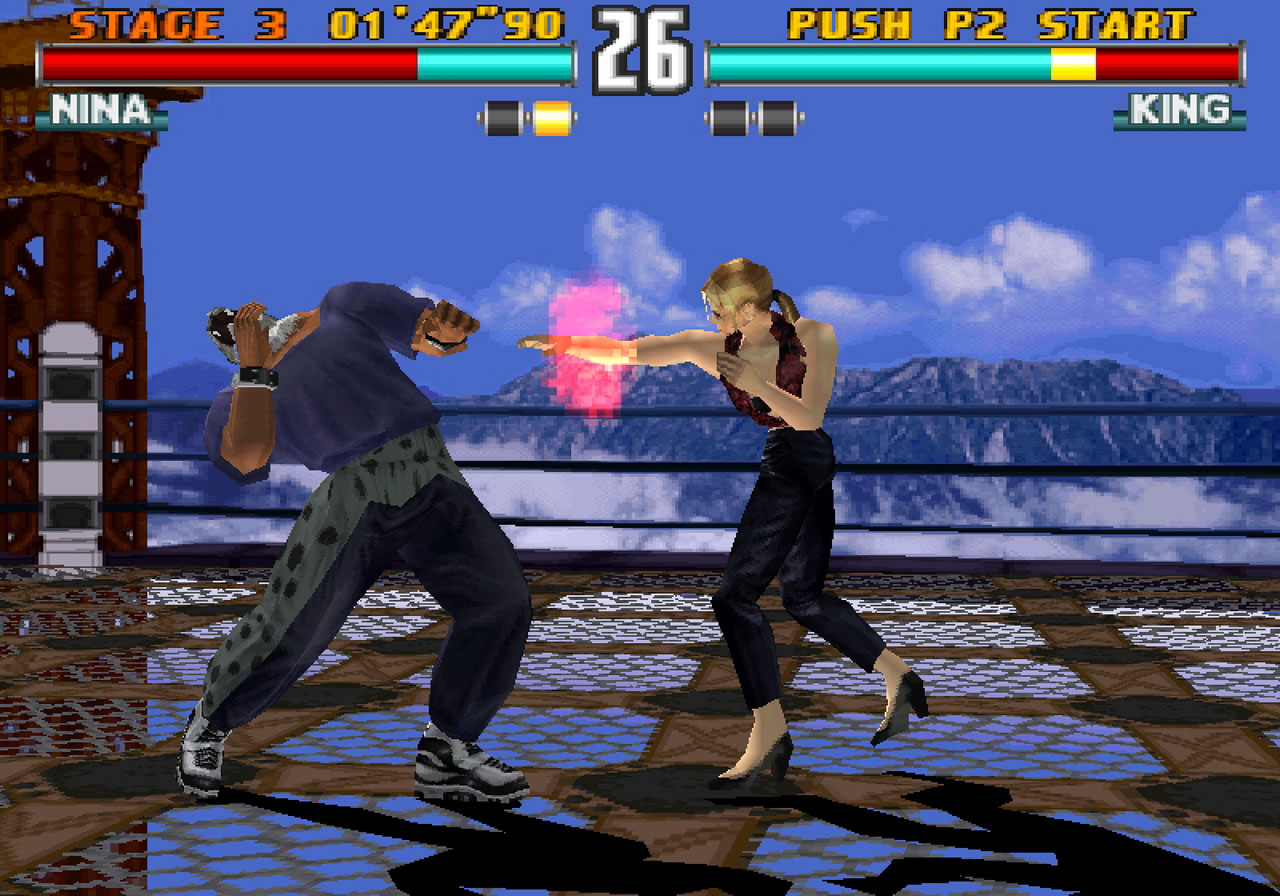 Nina striking King during a Tekken 3 fight on the original PlayStation